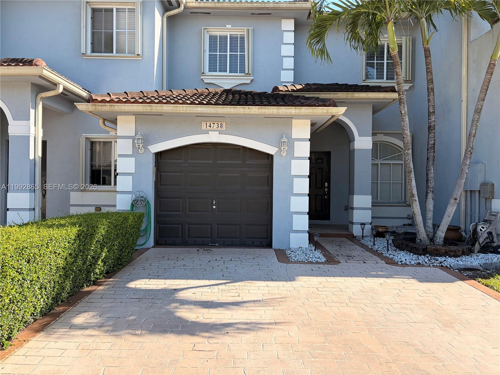 14738 Southwest 22nd Terrace Miami, FL 33185 - Photo 2 of 46 a front view of a house with a garden