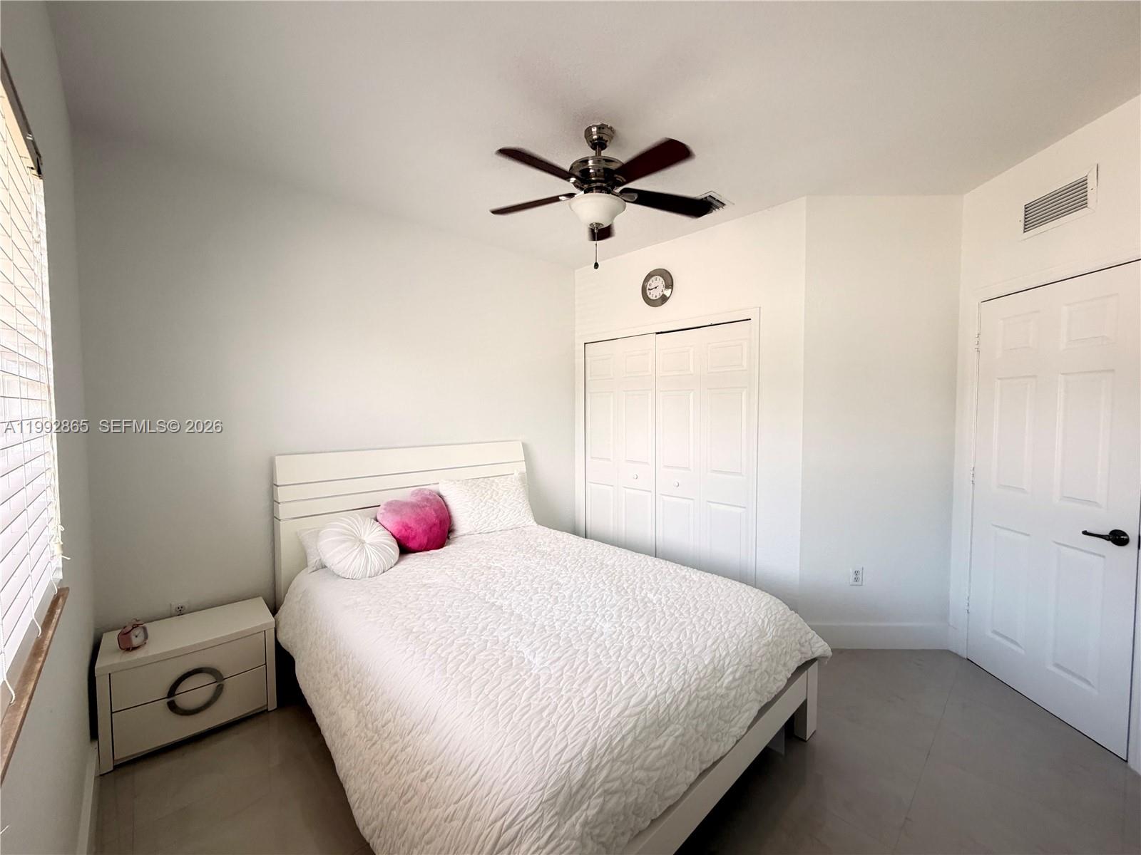 14738 Southwest 22nd Terrace Miami, FL 33185 - Photo 24 of 46 a bedroom with a bed and a chandelier