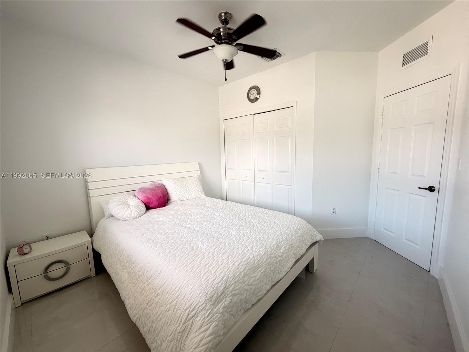 14738 Southwest 22nd Terrace Miami, FL 33185 - Photo 25 of 46 a bedroom with a bed and a chandelier