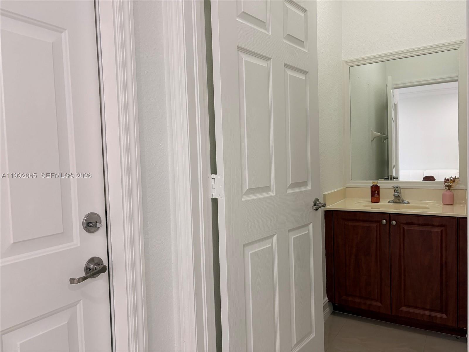 14738 Southwest 22nd Terrace Miami, FL 33185 - Photo 30 of 46 a bathroom with a sink and mirror