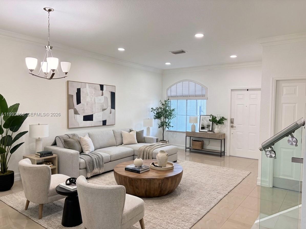 14738 Southwest 22nd Terrace Miami, FL 33185 - Photo 3 of 46 a living room with furniture and a chandelier