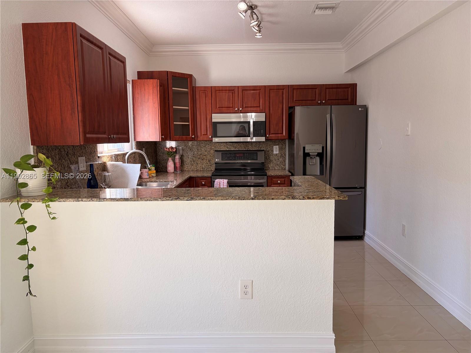 14738 Southwest 22nd Terrace Miami, FL 33185 - Photo 7 of 46 a kitchen with stainless steel appliances a refrigerator and a counter space