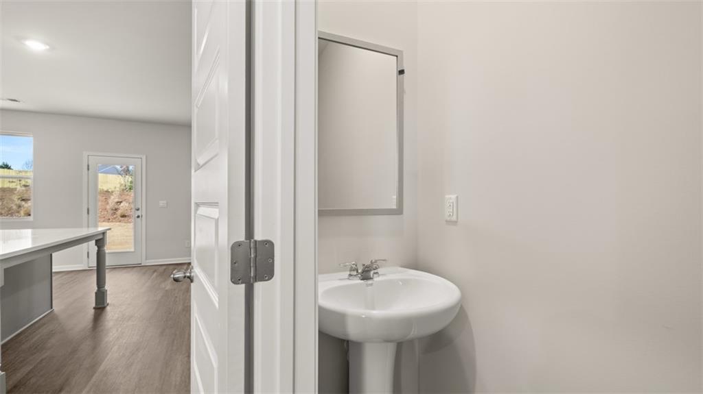 112 Holland Cove Winder, GA 30680 - Photo 13 of 26 a bathroom with a sink a mirror and shower