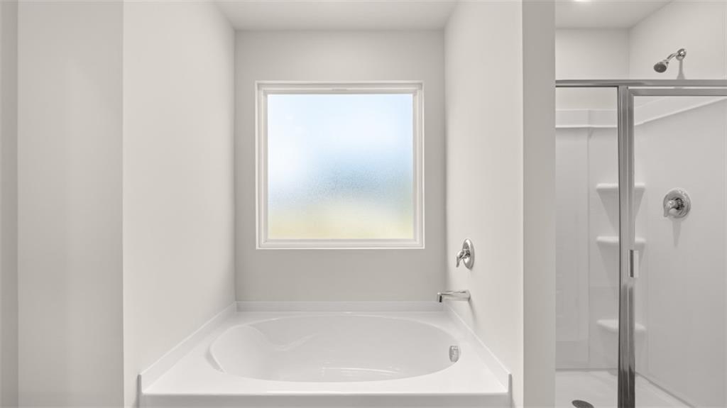 112 Holland Cove Winder, GA 30680 - Photo 17 of 26 a white bath tub sitting next to a shower