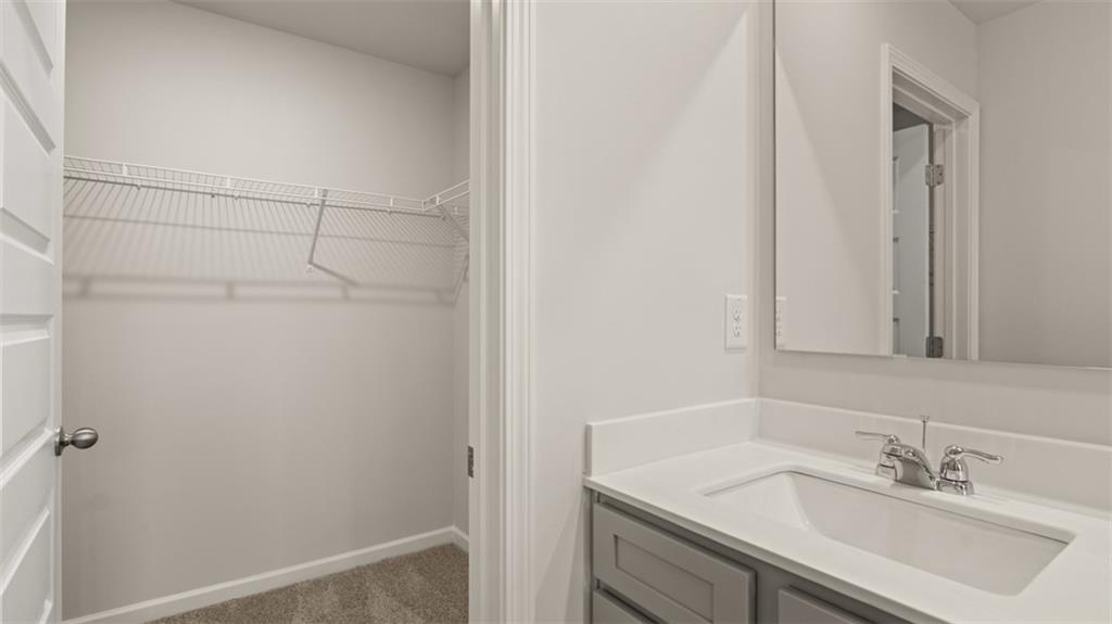 112 Holland Cove Winder, GA 30680 - Photo 18 of 26 a bathroom with a sink and a mirror