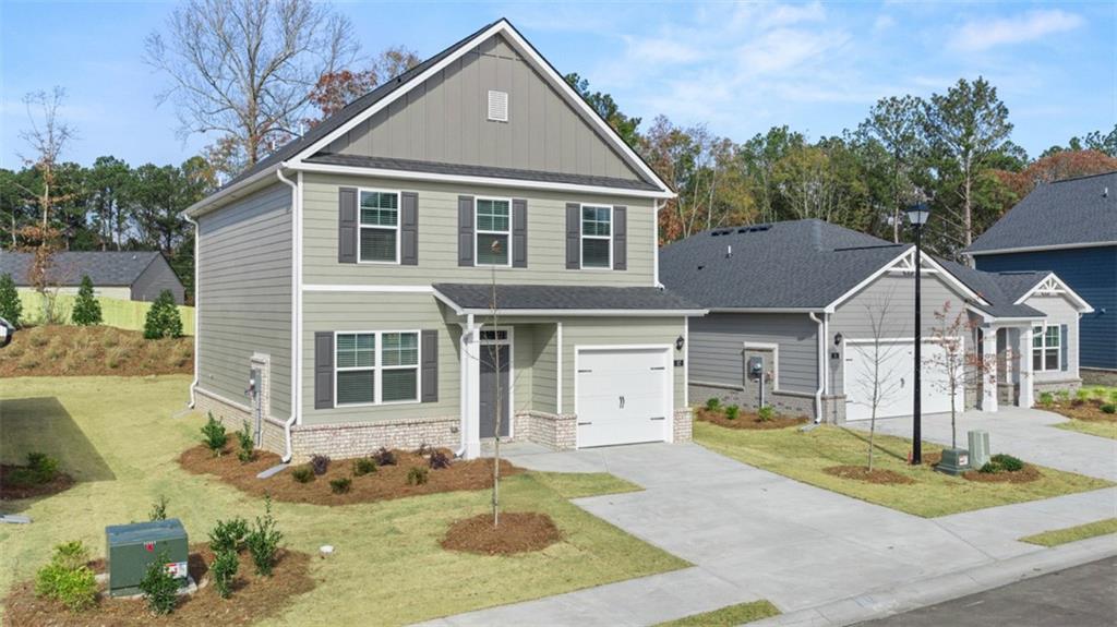 112 Holland Cove Winder, GA 30680 - Photo 2 of 26 a front view of a house with a yard