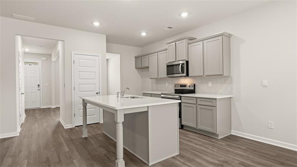 112 Holland Cove Winder, GA 30680 - Photo 8 of 26 a kitchen with a sink cabinets and wooden floor