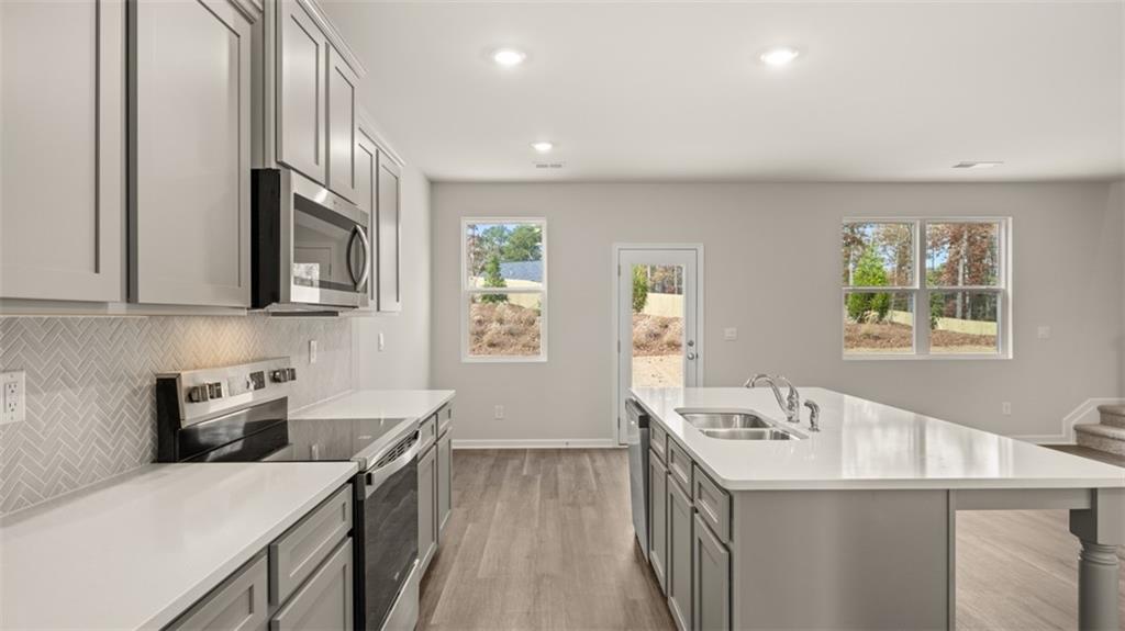 112 Holland Cove Winder, GA 30680 - Photo 9 of 26 a kitchen that has a sink and a stove in it