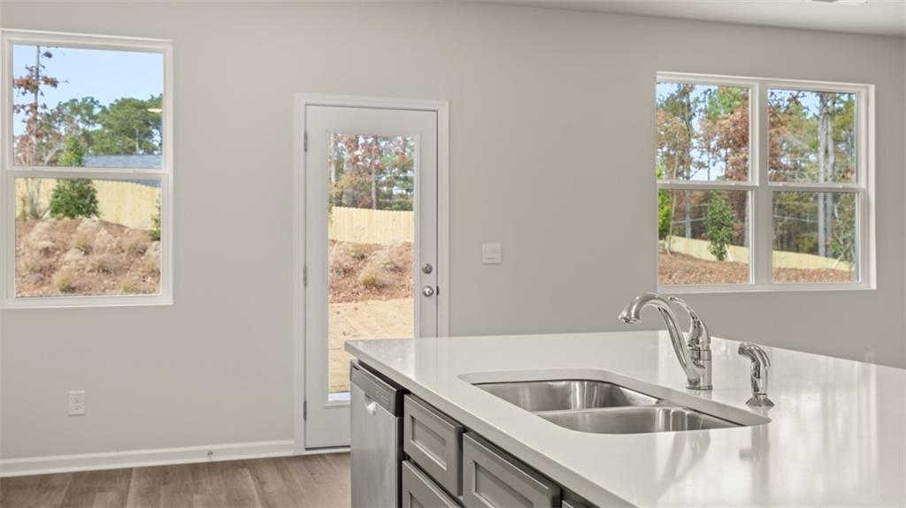 112 Holland Cove Winder, GA 30680 - Photo 10 of 26 a kitchen with granite countertop a sink and a window