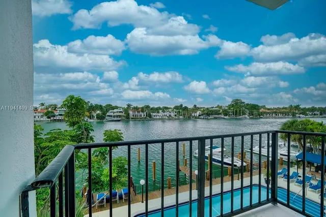 a view of a lake with houses in the back