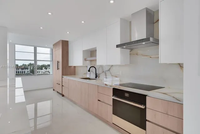 a kitchen with stainless steel appliances a sink stove and cabinets