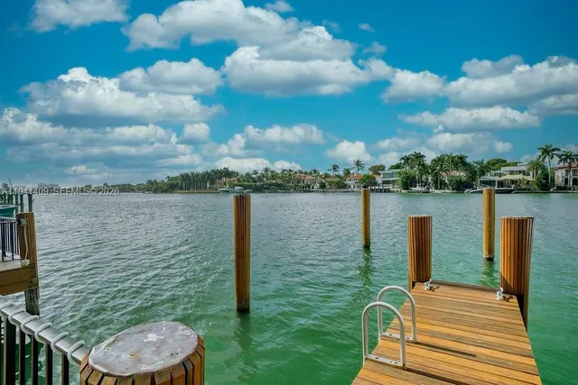 a bathroom with a sink mirror and shower