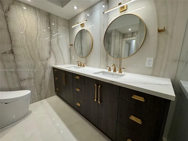a bathroom with a sink double vanity and a mirror