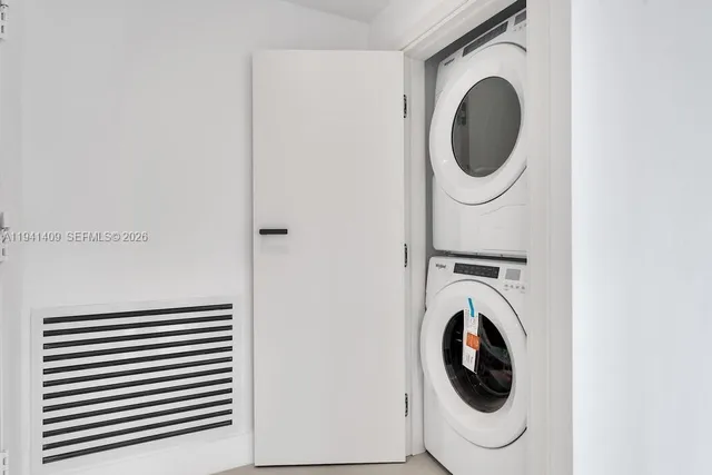 a view of a big room with kitchen and windows