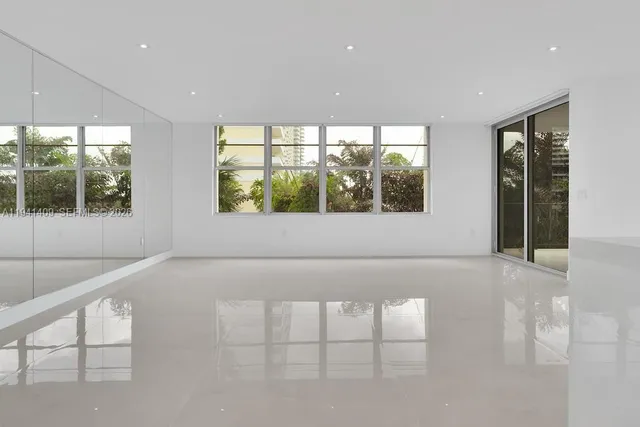 a view of a kitchen with a sink and a refrigerator