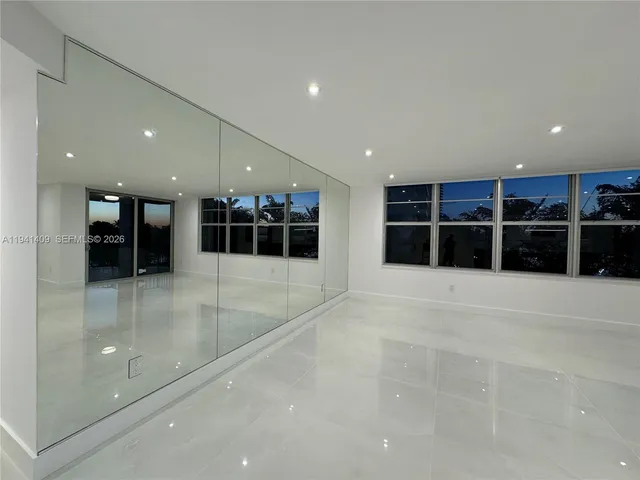 a bathroom with a sink mirror and shower