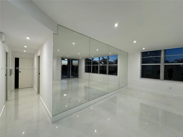 a bathroom with a sink mirror and shower