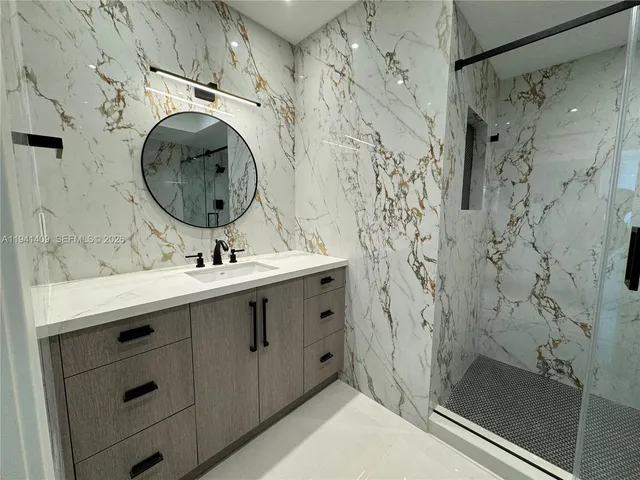 a view of empty room with furniture and refrigerator