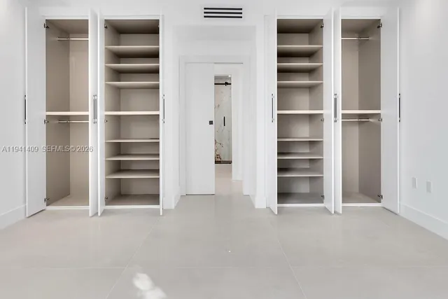 an empty room with large windows