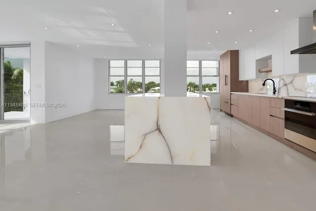 a living room with furniture a large window and a table