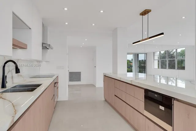 a kitchen with counter top space cabinets and sink
