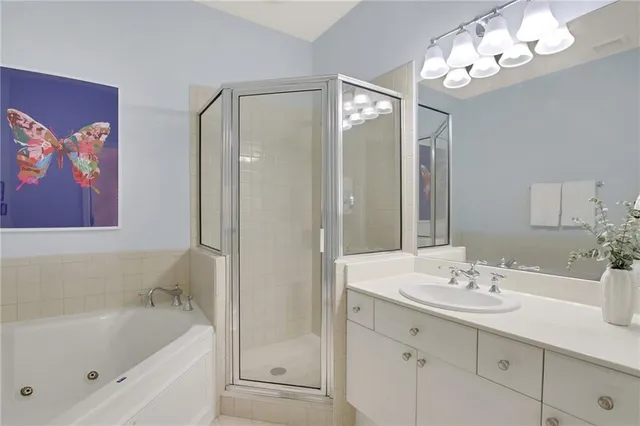 a bathroom with a tub a sink and a mirror