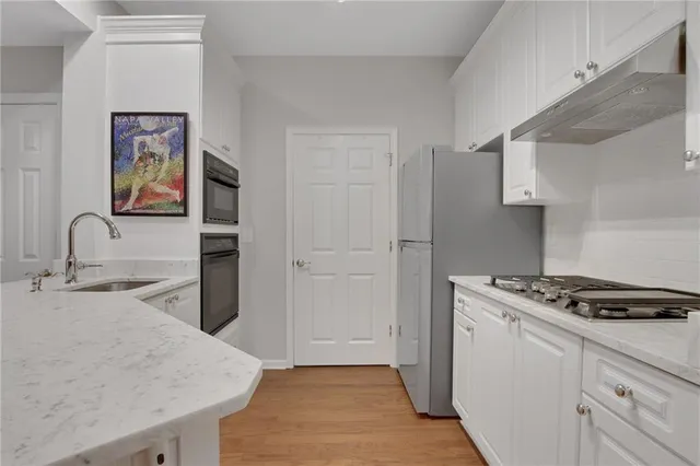 a kitchen with granite countertop a stove and a sink