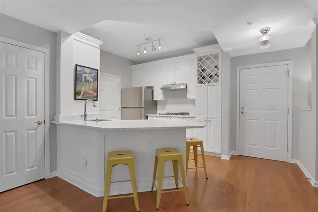 a kitchen with a sink cabinets and dining table chair