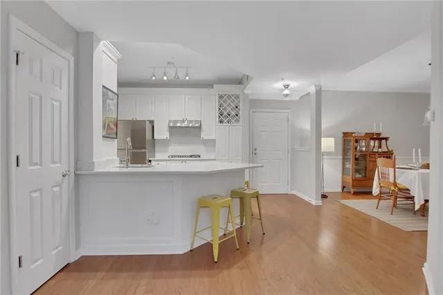 a kitchen with kitchen island a stove a table and chairs in it