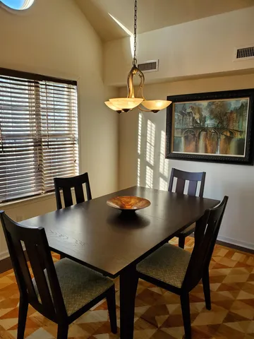 a view of a dining room with furniture and window