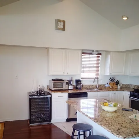 a kitchen with sink refrigerator and window