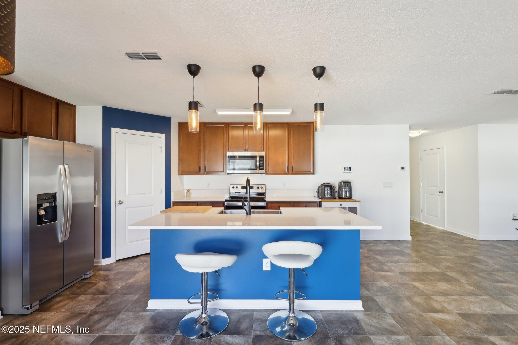 11461 Nathaniel Gorham Way Jacksonville, FL 32221 - Photo 15 of 42 a kitchen with a refrigerator a sink and a stove