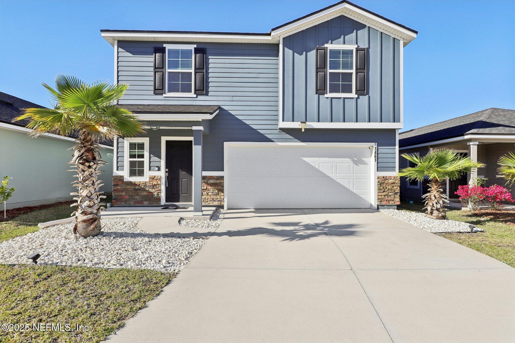 11461 Nathaniel Gorham Way Jacksonville, FL 32221 - Photo 2 of 42 a front view of a house with a yard and garage