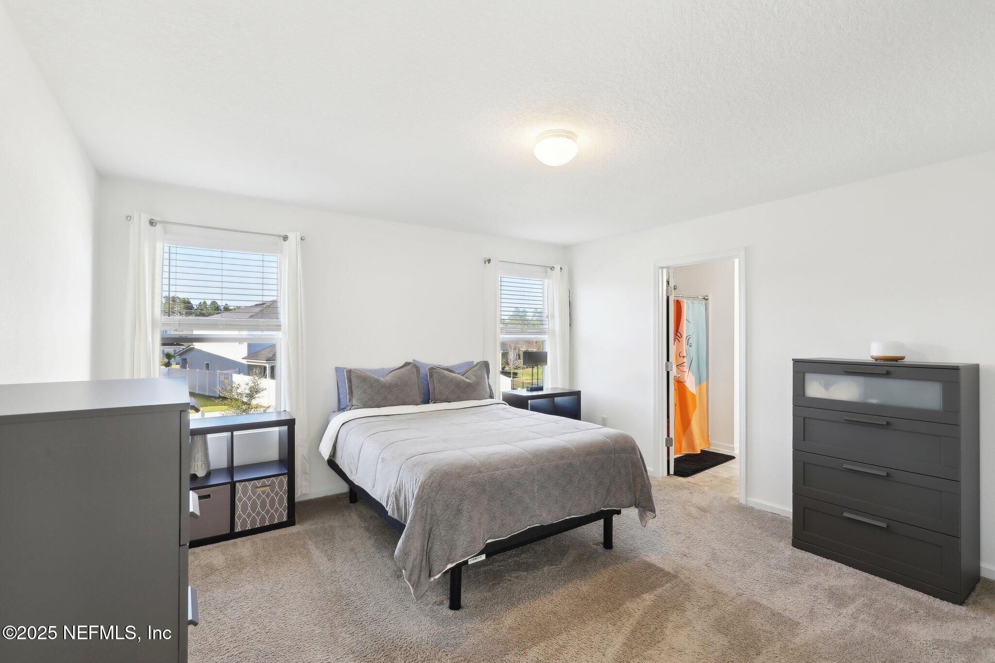 11461 Nathaniel Gorham Way Jacksonville, FL 32221 - Photo 27 of 42 a bedroom with a bed and a window