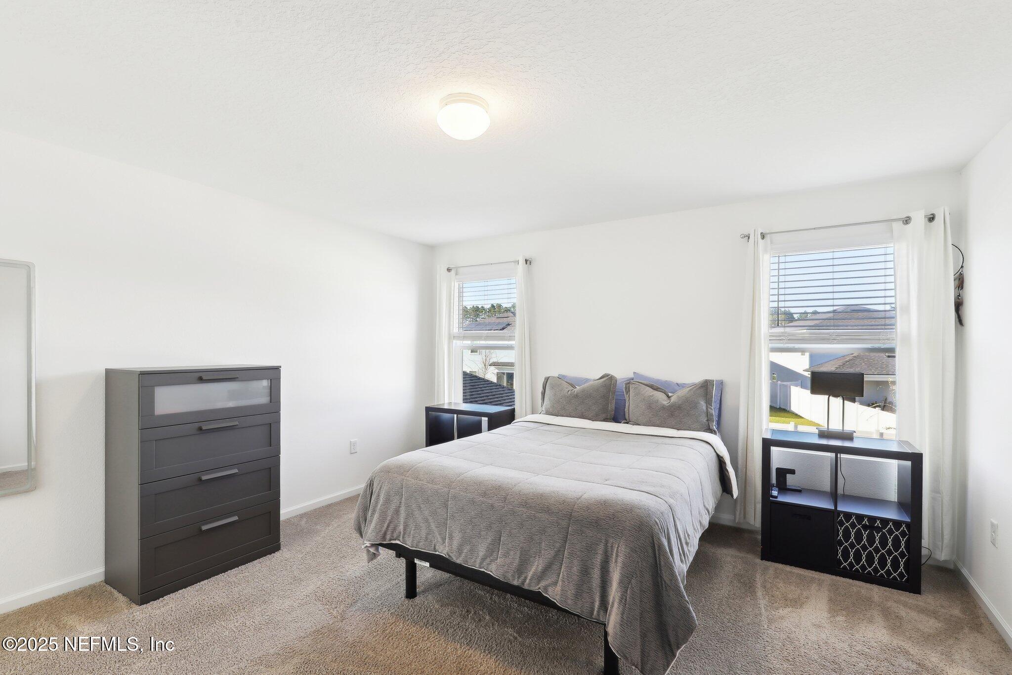 11461 Nathaniel Gorham Way Jacksonville, FL 32221 - Photo 29 of 42 a bedroom with a bed and a window