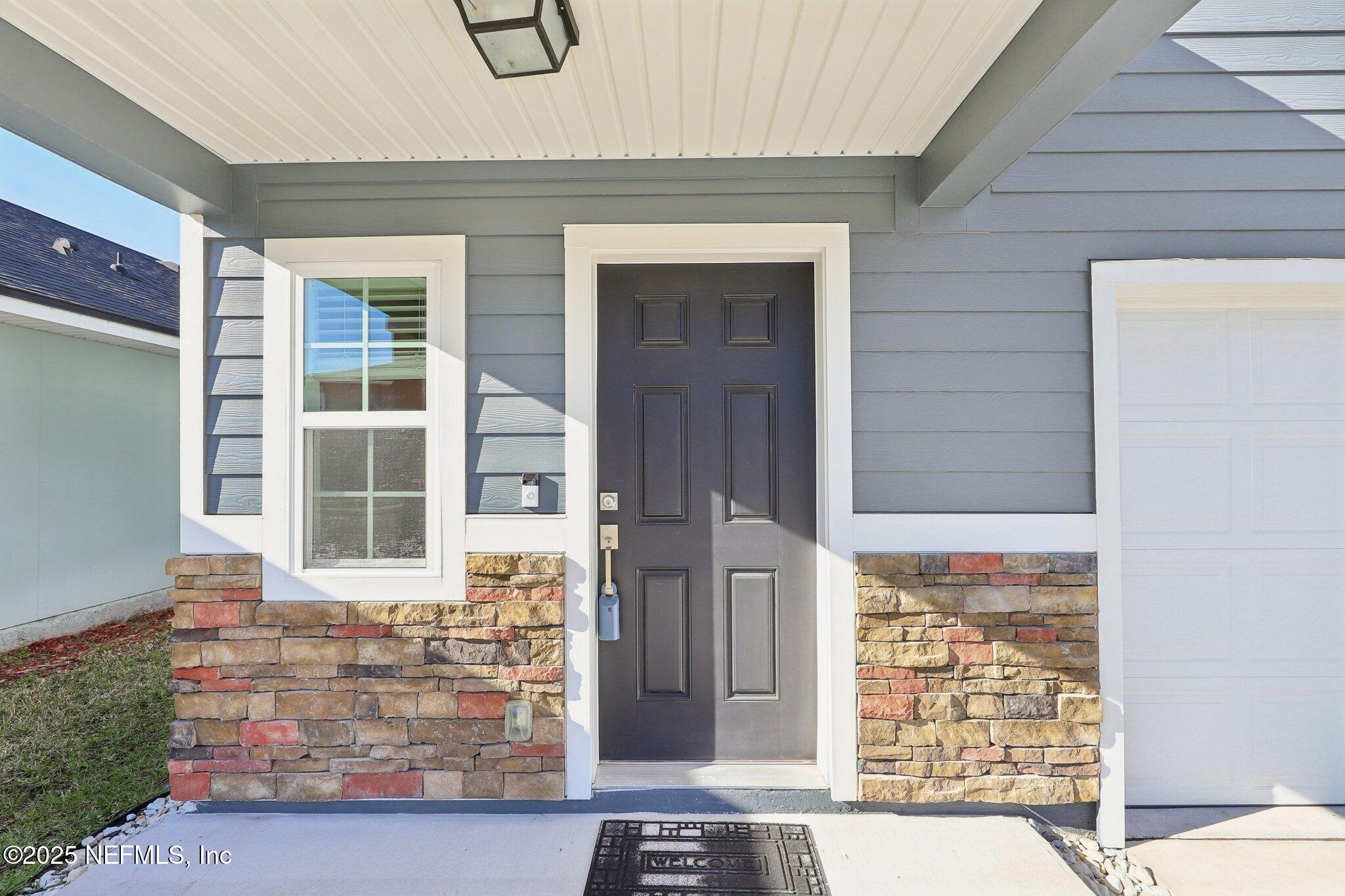 11461 Nathaniel Gorham Way Jacksonville, FL 32221 - Photo 3 of 42 a front view of a house with a parking area