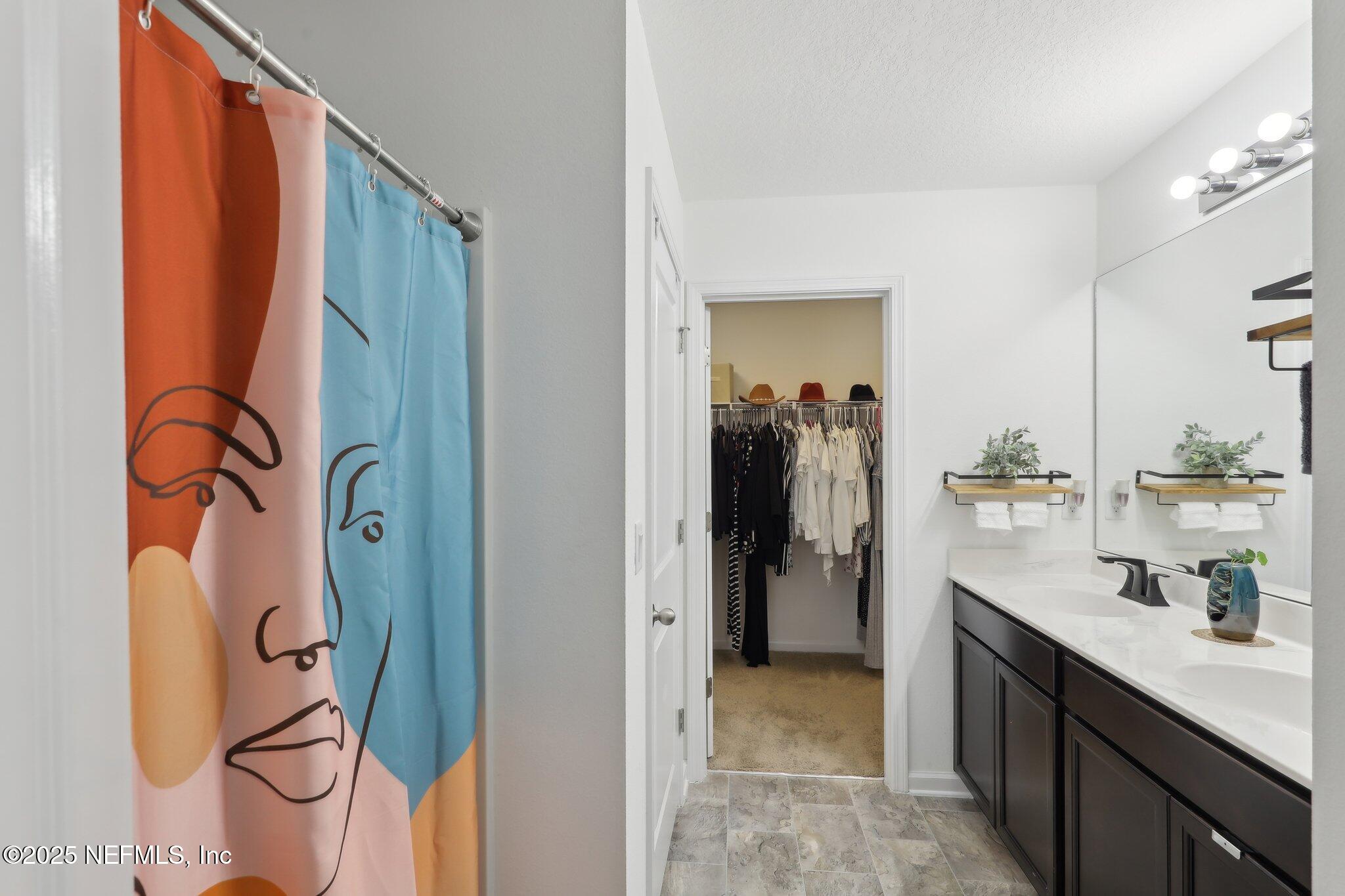 11461 Nathaniel Gorham Way Jacksonville, FL 32221 - Photo 32 of 42 a bathroom with a sink and mirror with shower