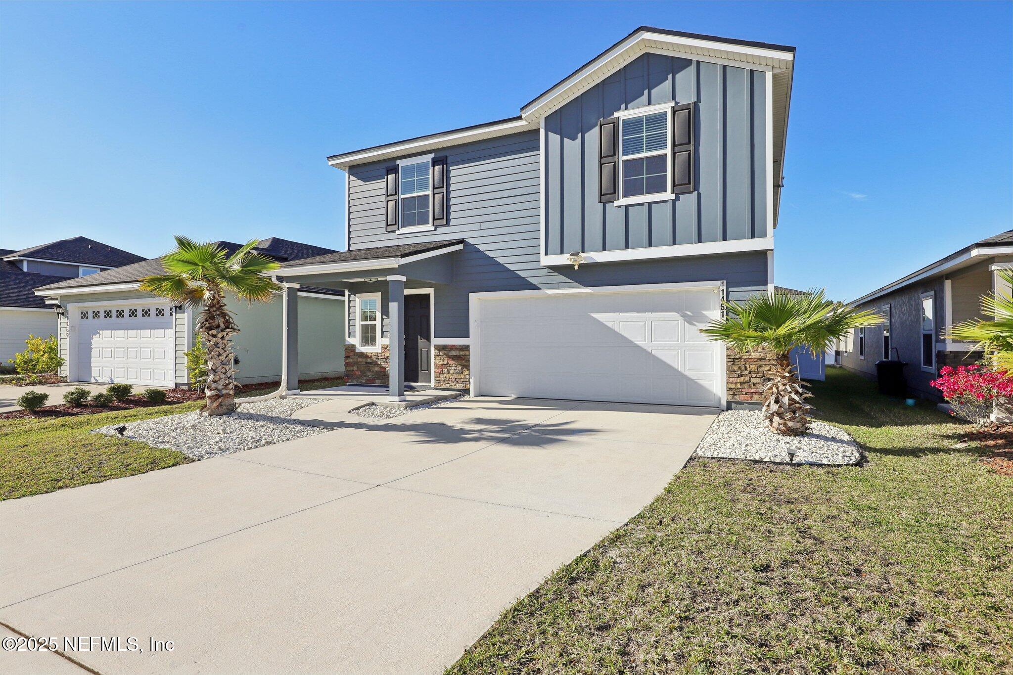 11461 Nathaniel Gorham Way Jacksonville, FL 32221 - Photo 5 of 42 a front view of a house with a yard and garage