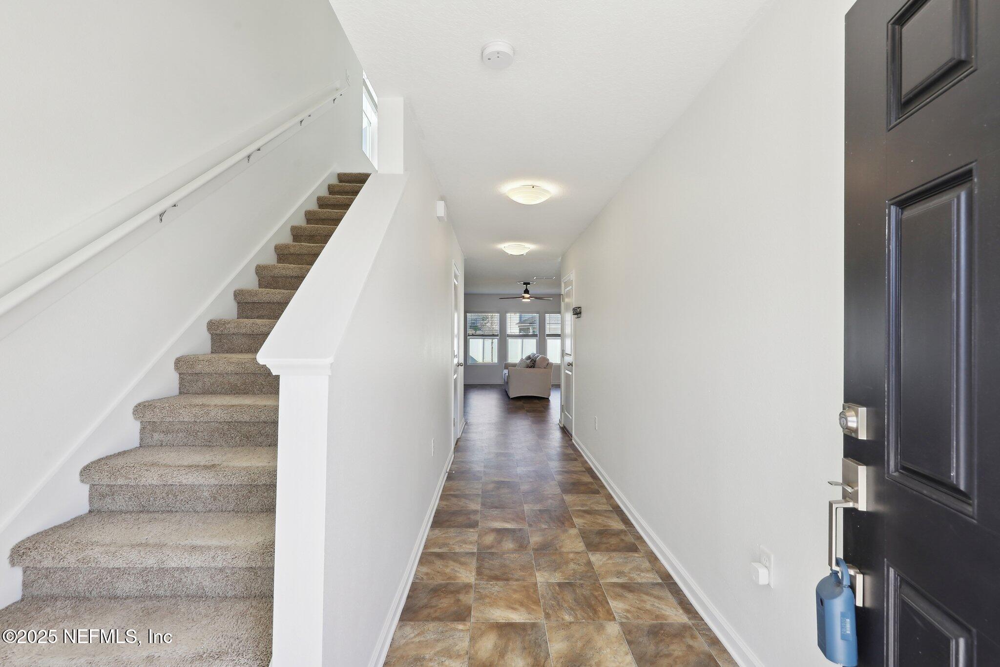 11461 Nathaniel Gorham Way Jacksonville, FL 32221 - Photo 8 of 42 a view of a hallway with wooden floor and staircase