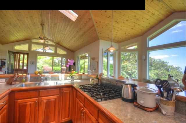 1629 West Kuiaha Road Haiku, HI 96708 - Photo 11 of 29 a kitchen with a large window a sink and appliances