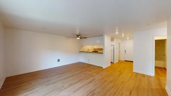 a view of a room with wooden floor