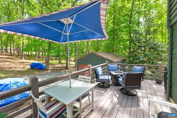 a view of backyard with seating space and trees