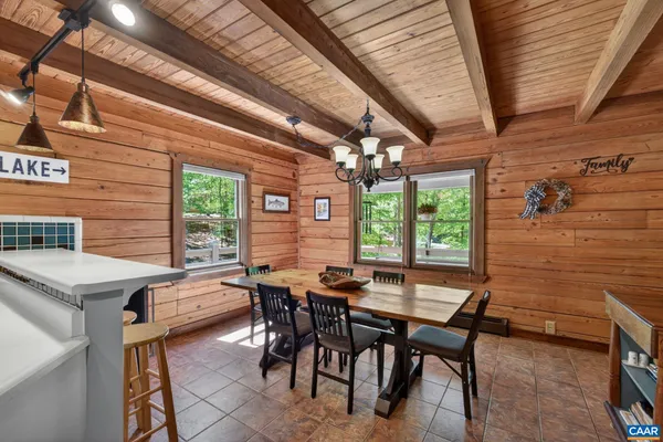 a kitchen with a table chairs and a wooden floor