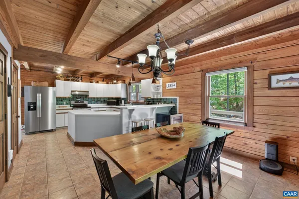 a kitchen with sink and chairs
