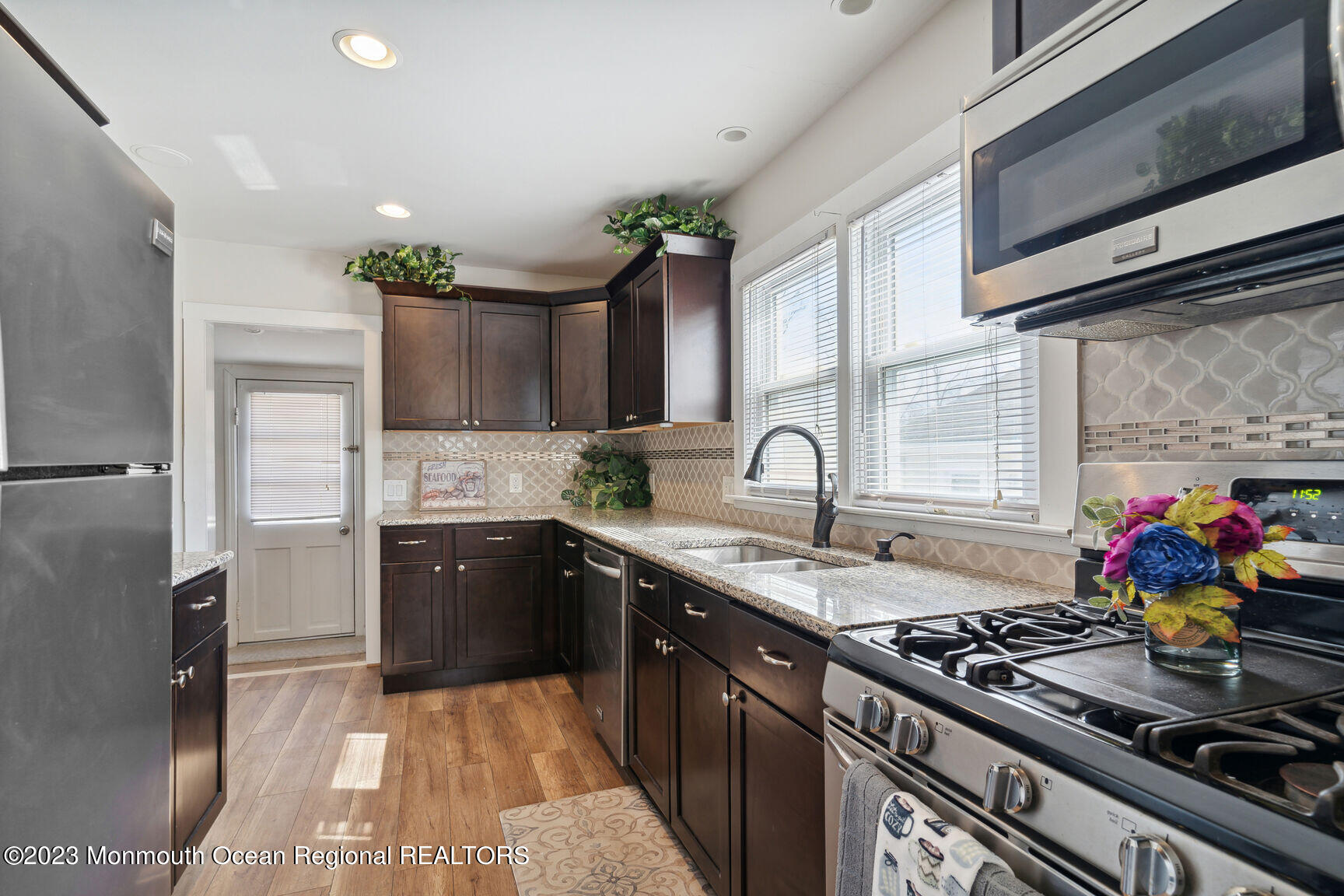 414 Drum Point Road Brick, NJ 08723 - Photo 7 of 16 a kitchen with stainless steel appliances granite countertop a sink stove and refrigerator