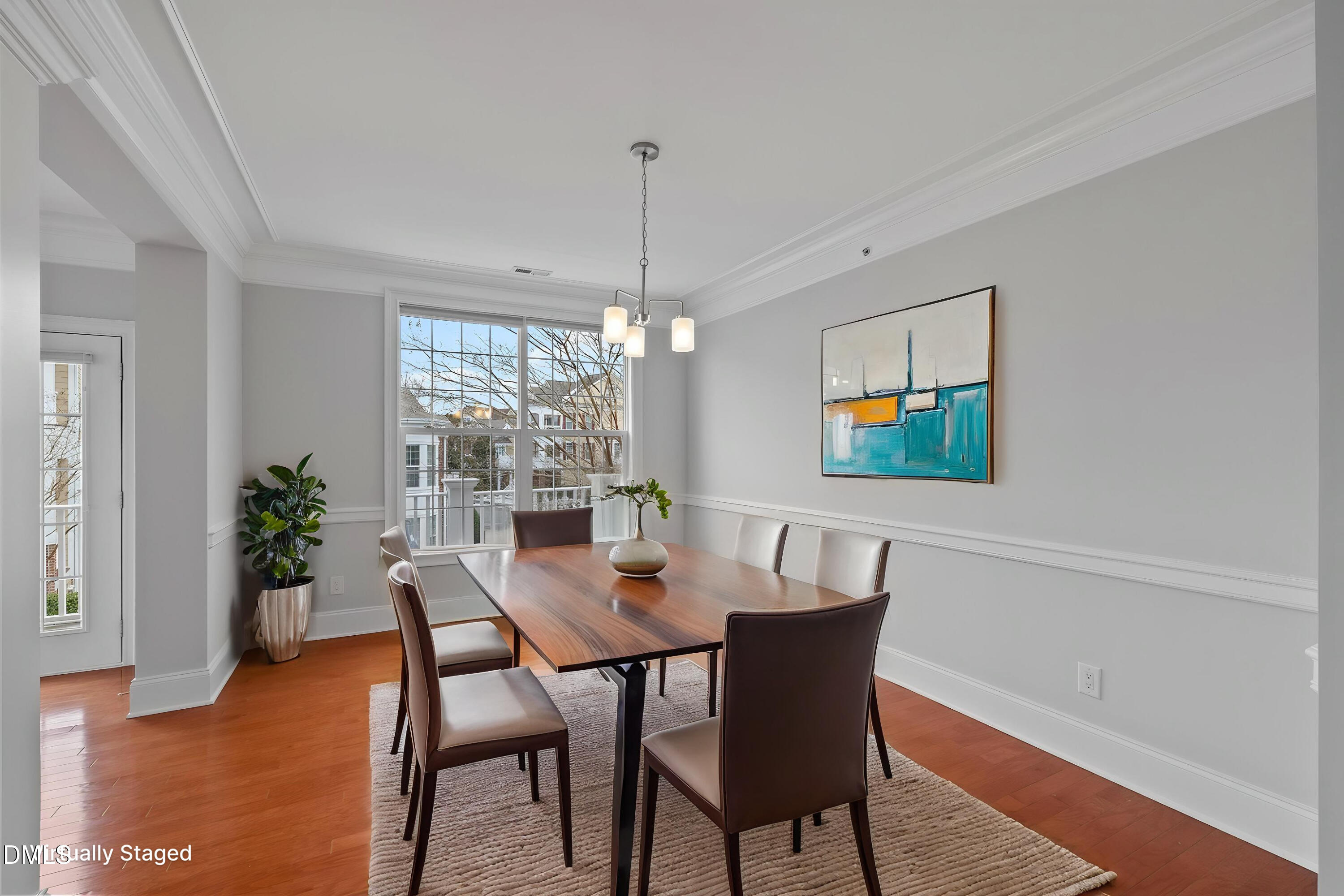 9211 Calabria Drive, Unit 205 Raleigh, NC 27617 - Photo 8 of 55 a dining room with furniture potted plants and wooden floor