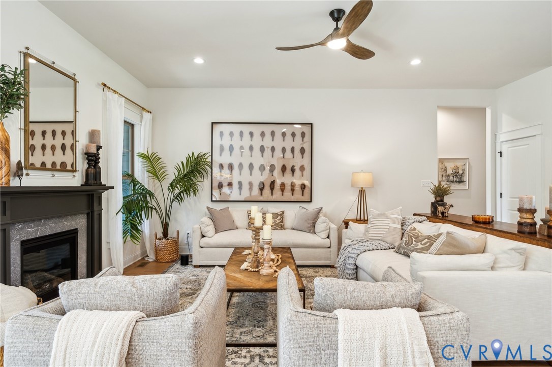 7751 Dandridge Drive Quinton, VA 23141 - Photo 3 of 19 a living room with furniture a fireplace and a large mirror