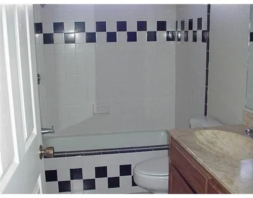a view of a kitchen with stainless steel appliances granite countertop a sink and a refrigerator