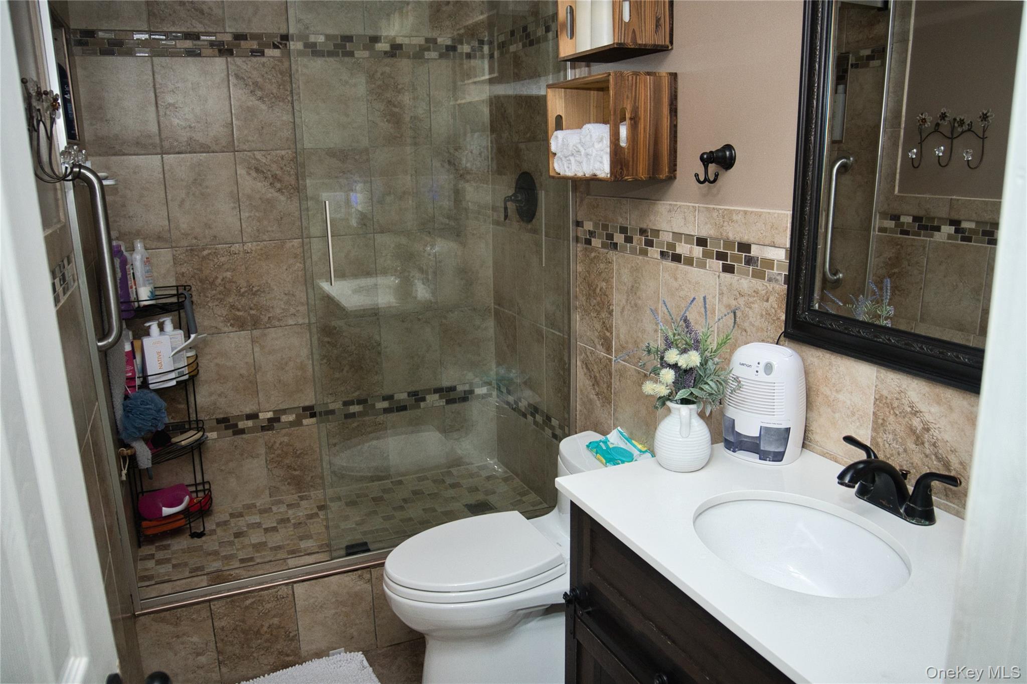 165 Lattintown Road, Unit 75 Newburgh, NY 12550 - Photo 10 of 24 Bathroom featuring vanity, a walk in shower, and tile walls