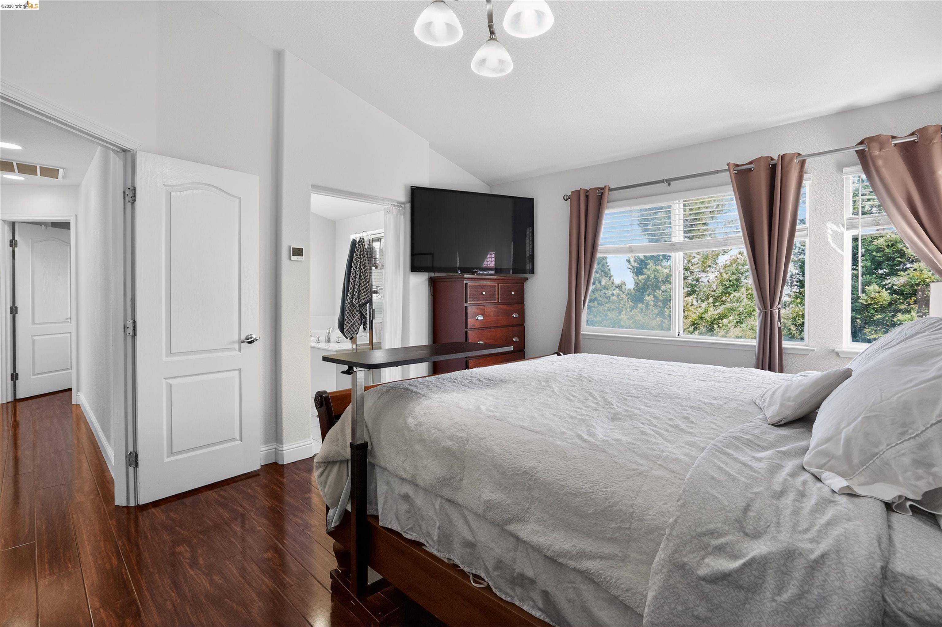 1221 Andrea Way Vallejo, CA 94591 - Photo 16 of 29 Room featuring rich wood-finish flooring, white paneled doors, and an entry to a full bathroom